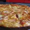 Вкуснейшая пицца с ветчиной, моцареллой и плавленым сыром